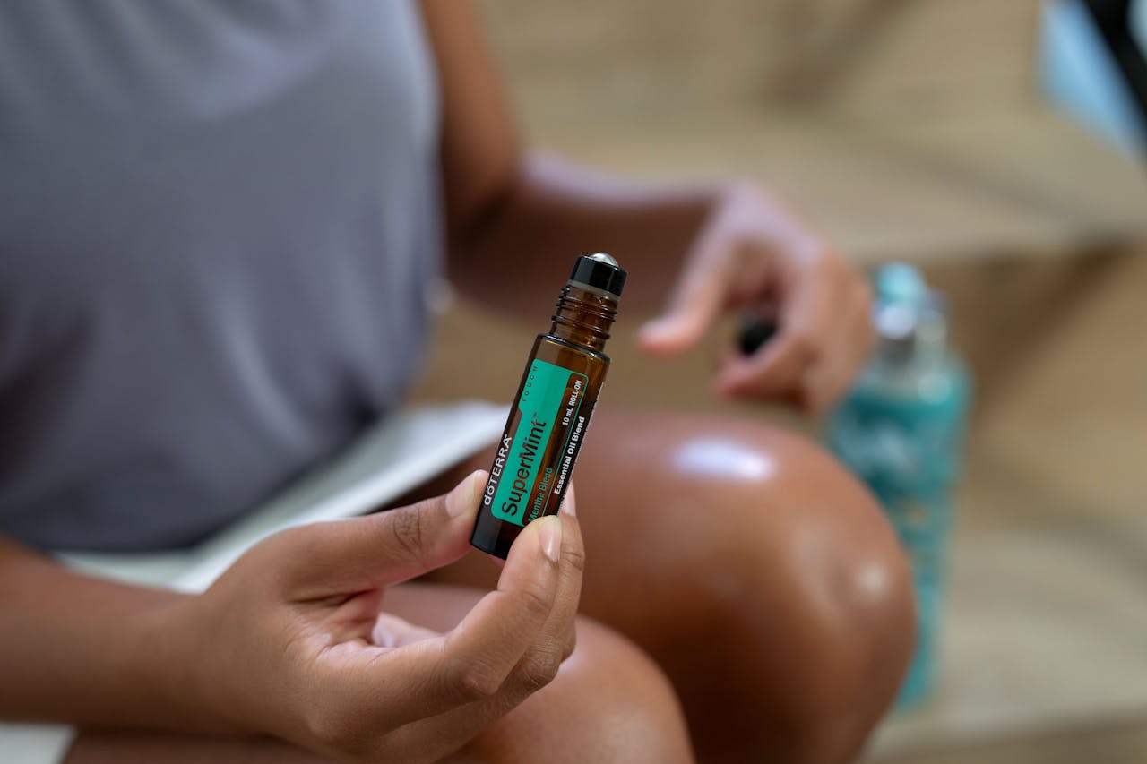 journey A woman holding a roller bottle of doTERRA SuperMint essential oil close-up shot.