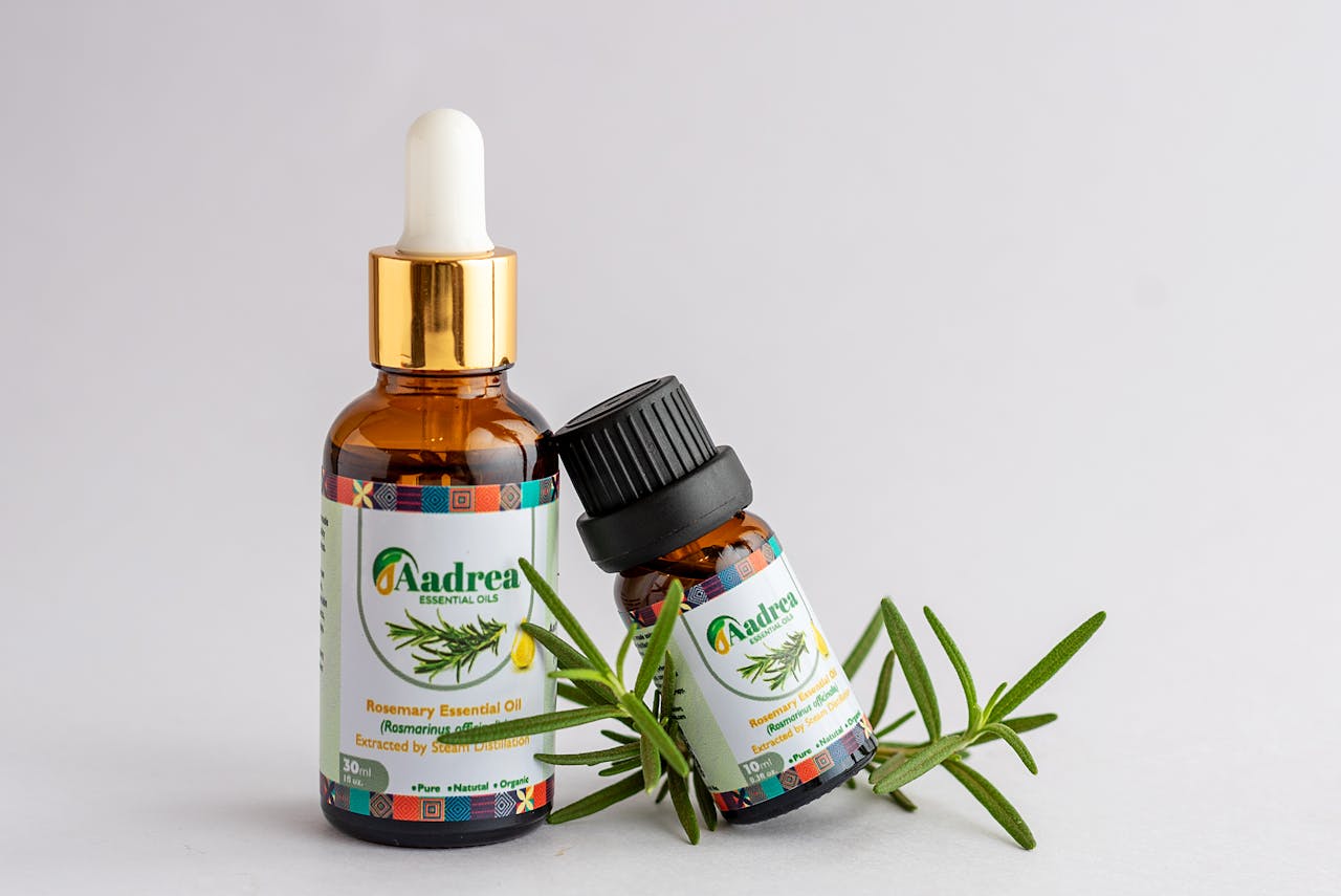 services-01 Close-up of rosemary essential oil bottles with fresh rosemary sprig, offering natural aromatic healing.