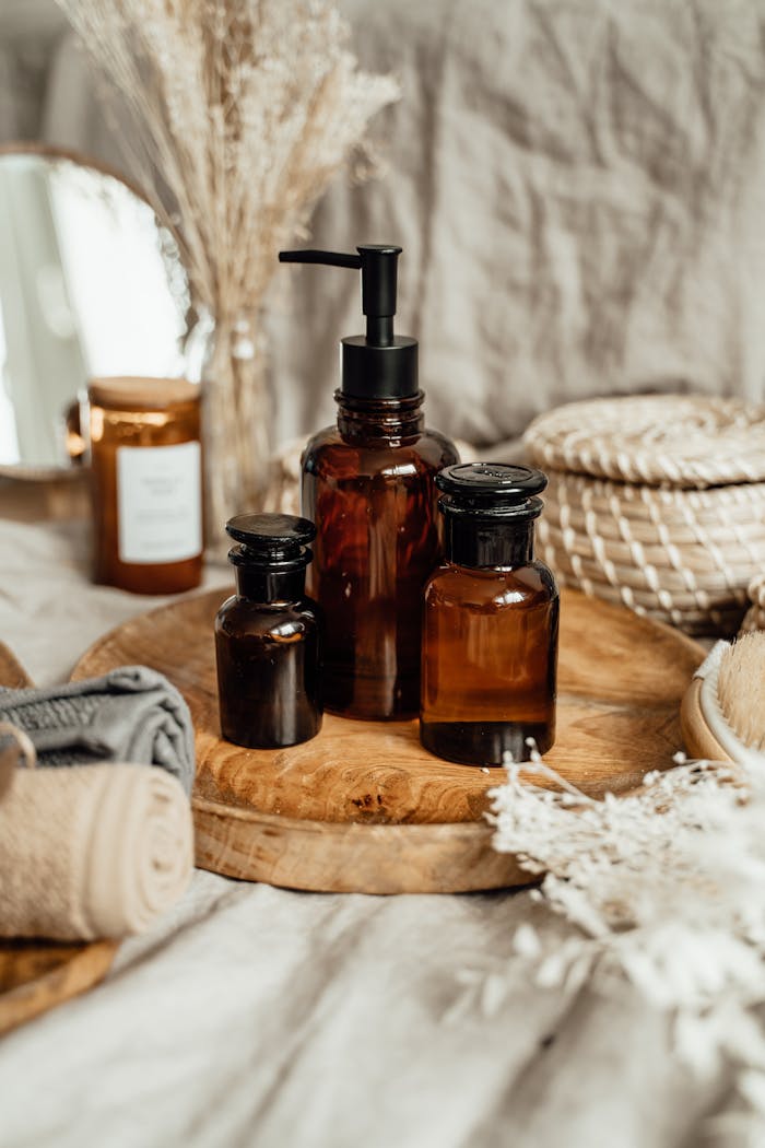Stylish arrangement of brown glass aromatherapy bottles with natural decor in a soft indoor setting.